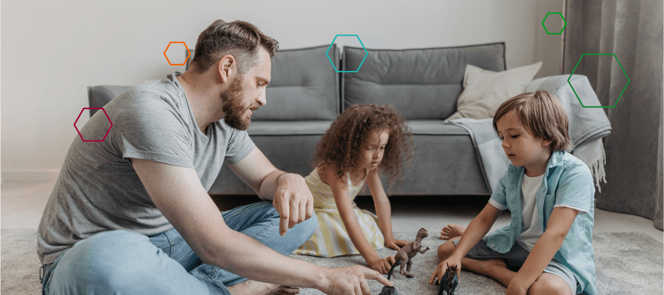 Father playing on floor with children